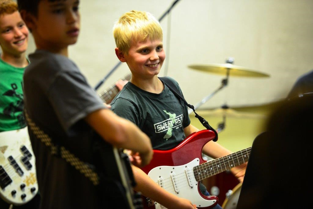 boys playing guitar at rock and roll summer music camp