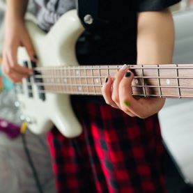 girl playing bass guitar at home.jpg