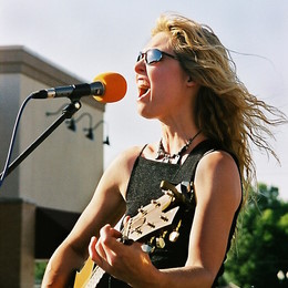 female rock guitarist performing at show.jpg