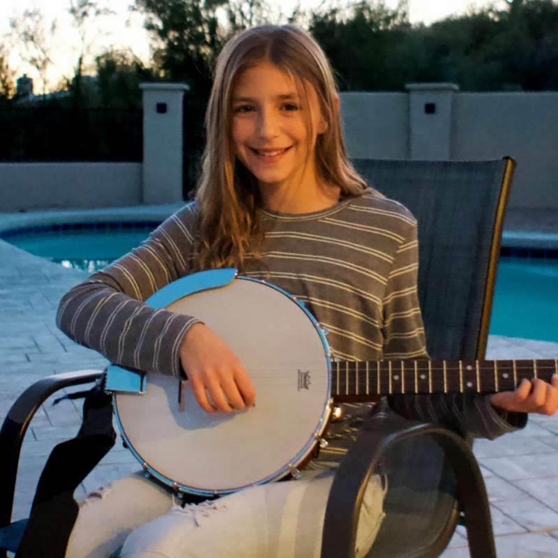 Young girl playing banjo in private banjo lesson