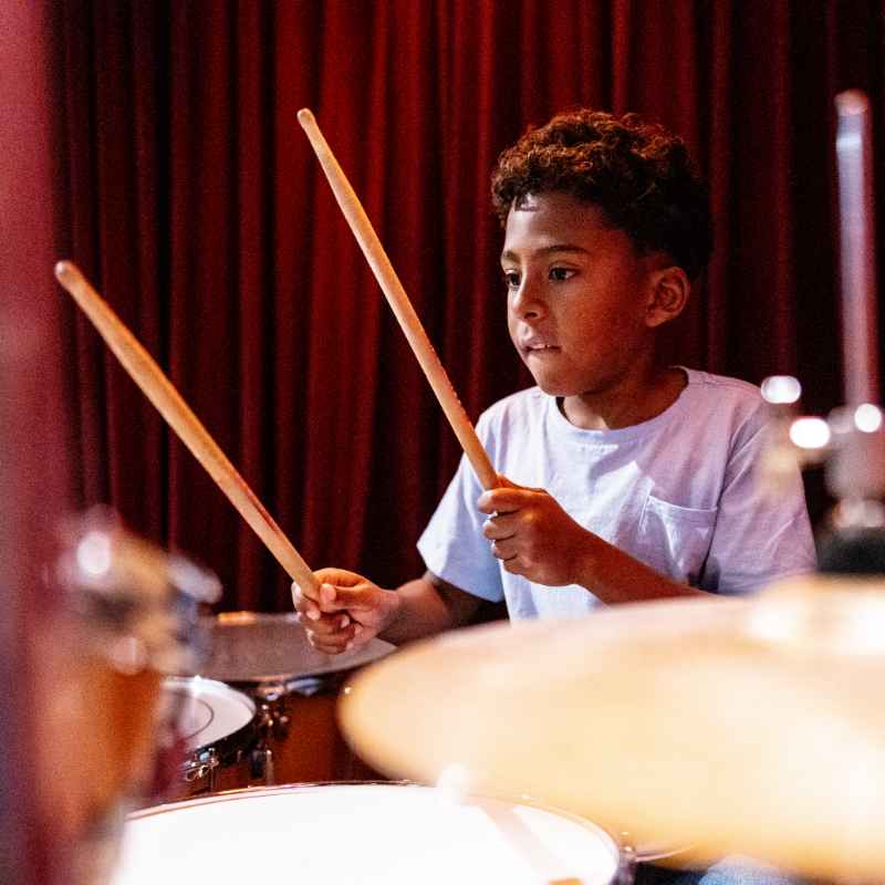 Youth learning to play drums in a private 1 on 1 drum lesson