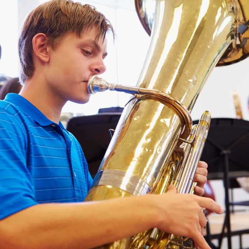 Teen playing tuba in private tuba lessons.