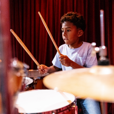 Youth learning to play drums in a private 1 on 1 drum lesson