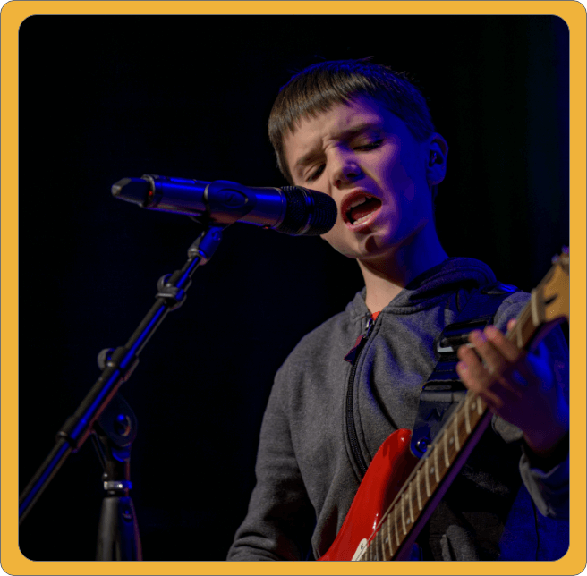 Teen boy singing at concert